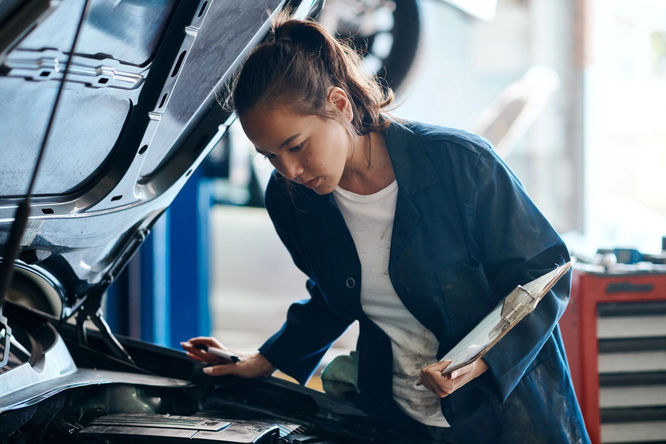 Mechanic working on a car in an auto repair shop